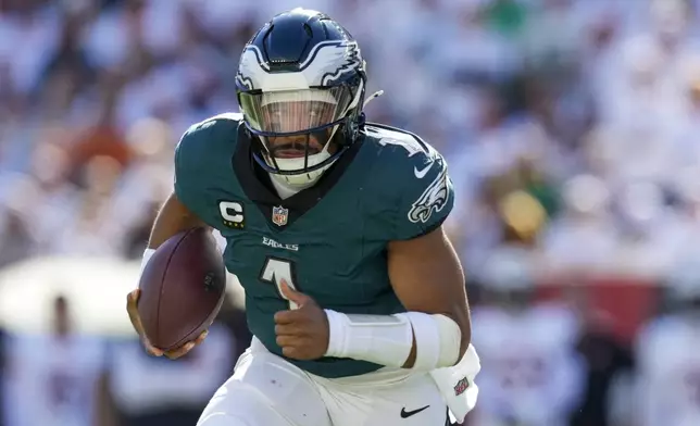 Philadelphia Eagles quarterback Jalen Hurts scrambles against the Cincinnati Bengals during the second half of an NFL football game, Sunday, Oct. 27, 2024 in Cincinnati. (AP Photo/Carolyn Kaster)