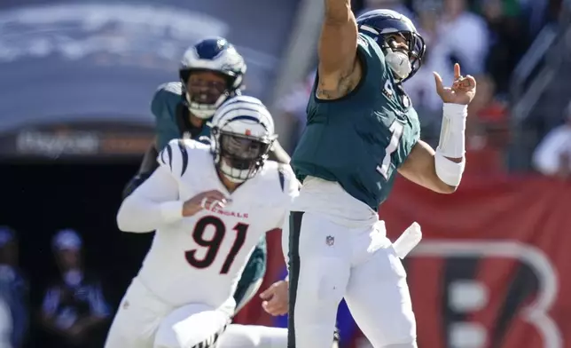 Philadelphia Eagles quarterback Jalen Hurts (1) launches a long touchdown pass to wide receiver DeVonta Smith during the second half of an NFL football game against the Cincinnati Bengals, Sunday, Oct. 27, 2024 in Cincinnati. (AP Photo/Carolyn Kaster)