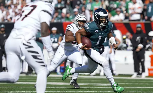 Philadelphia Eagles quarterback Jalen Hurts (1) runs for yardage against the Cincinnati Bengals during the first half of an NFL football game, Sunday, Oct. 27, 2024 in Cincinnati. (AP Photo/Jeff Dean)