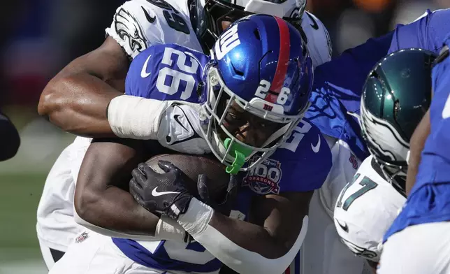 New York Giants running back Devin Singletary (26) carries the ball against the Philadelphia Eagles during the second quarter of an NFL football game, Sunday, Oct. 20, 2024, in East Rutherford, N.J. (AP Photo/Seth Wenig)