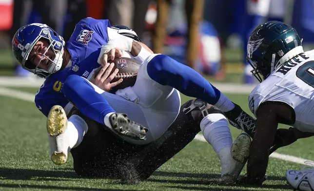 New York Giants quarterback Daniel Jones (8) is sacked by Philadelphia Eagles linebacker Josh Sweat (19) during the first quarter of an NFL football game, Sunday, Oct. 20, 2024, in East Rutherford, N.J. (AP Photo/Frank Franklin II)