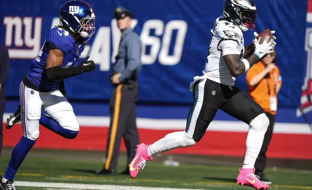 Philadelphia Eagles wide receiver A.J. Brown (11) makes a touchdown catch ahead of New York Giants cornerback Nick McCloud (44) during the second quarter of an NFL football game, Sunday, Oct. 20, 2024, in East Rutherford, N.J. (AP Photo/Frank Franklin II)