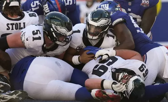 Philadelphia Eagles quarterback Jalen Hurts (1) pushes his way across the goal line for a touchdown against the New York Giants during the fourth quarter of an NFL football game, Sunday, Oct. 20, 2024, in East Rutherford, N.J. (AP Photo/Seth Wenig)