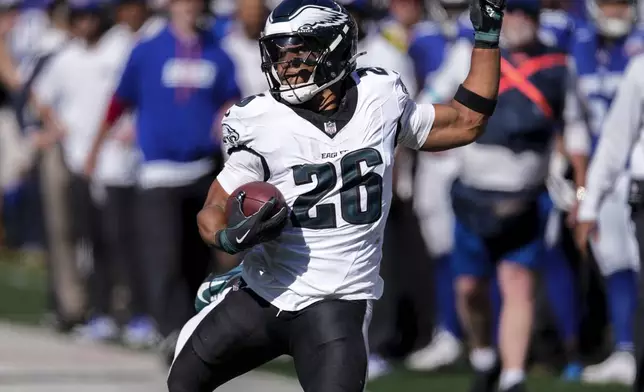 Philadelphia Eagles running back Saquon Barkley (26) carrie the ball for a first down against the New York Giants during the second quarter of an NFL football game, Sunday, Oct. 20, 2024, in East Rutherford, N.J. (AP Photo/Seth Wenig)