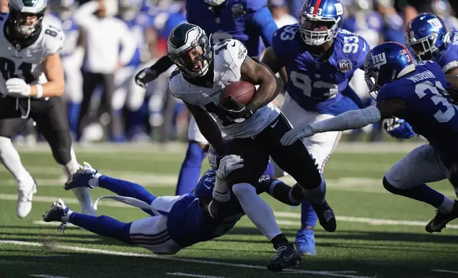 Philadelphia Eagles running back Kenneth Gainwell (14) carries the ball against the New York Giants during the fourth quarter of an NFL football game, Sunday, Oct. 20, 2024, in East Rutherford, N.J. (AP Photo/Frank Franklin II)