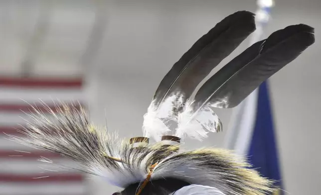 Eagle feathers adorn a headdress during a powwow in Montana, on April 6, 2024. (AP Photo/Matthew Brown)