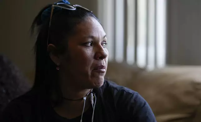 María Ángel Torres looks out the window during an interview at her apartment Friday, May 18, 2024, in Aurora, Colorado. (AP Photo/Jack Dempsey)