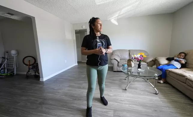 María Ángel Torres looks out the window during an interview at her apartment Friday, May 18, 2024, in Aurora, Colorado. (AP Photo/Jack Dempsey)