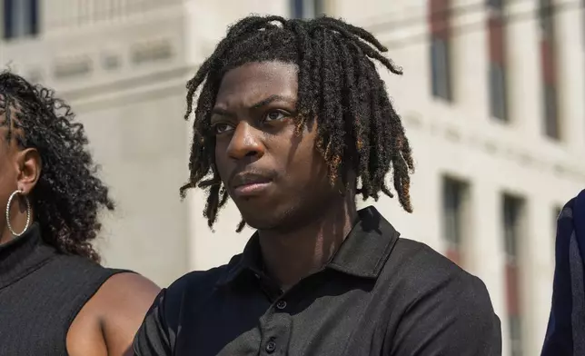 FILE - Darryl George stands next to his mother, Darresha George, in front of Galveston County Court House, May 23, 2024, in Galveston, Texas. A federal judge on Friday, Oct. 4, 2024 denied a request by Darryl George, a Black high school student in Texas for a court order that the student’s lawyers say would have allowed him to return to his high school without fear of having his previous punishment over his hairstyle resume.(Raquel Natalicchio/Houston Chronicle via AP, File)