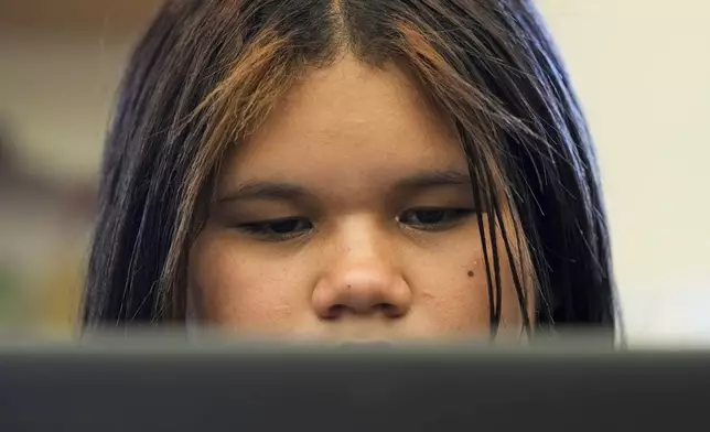 Alisson Ramírez uses a laptop to work on an assignment during science class Wednesday, Aug. 28, 2024, in Aurora, Colo. (AP Photo/Godofredo A. Vásquez)