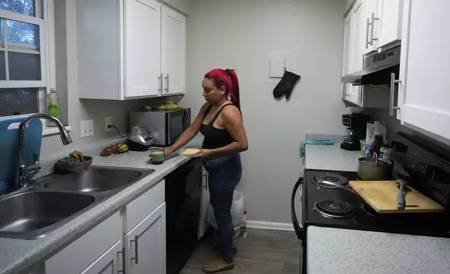 Gabriela Ramírez prepares breakfast for her son Thursday, Aug. 29, 2024, in Aurora, Colo. (AP Photo/Godofredo A. Vásquez)