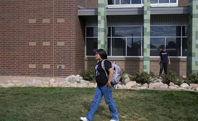 Alisson Ramírez walks to catch the school bus back home Wednesday, Aug. 28, 2024, in Aurora, Colo. (AP Photo/Godofredo A. Vásquez)