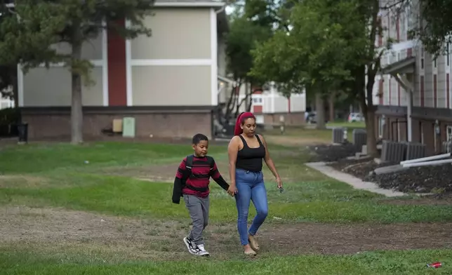 Gabriela Ramírez, right, walks her son Dylan to school Thursday, Aug. 29, 2024, in Aurora, Colo. (AP Photo/Godofredo A. Vásquez)