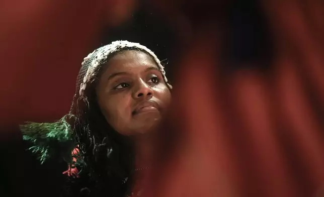 Sudanese Camirata troupe dancer Fatma Farid, 21, whose aunt was killed in 2023 when an explosive fell on their house in al-Obeid, the capital of North Kordofan, performs at the Italian culture center in Cairo, Egypt, Wednesday, July 24, 2024. (AP Photo/Amr Nabil)