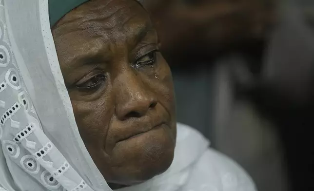 Sarah Naqd Allah, from Sudan's main opposition Umma Party, cries as she watches Camirata troupe traditional show at the Russian culture center in Cairo, Egypt, Sunday, Sept. 15, 2024. (AP Photo/Amr Nabil)