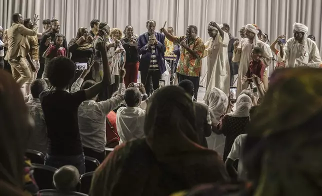 Sudanese Camirata troupe founder Dafallah el-Hag, center, greets Sudanese and foreign audience at the end of a show at the Russian culture center in Cairo, Egypt, Sunday, Sept. 15, 2024. (AP Photo/Amr Nabil)