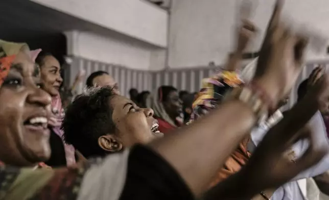 Sudanese refugees sitting in the audience cry as they watch Camirata troupe traditional show at the Russian culture center in Cairo, Egypt, Sunday, Sept. 15, 2024. (AP Photo/Amr Nabil)