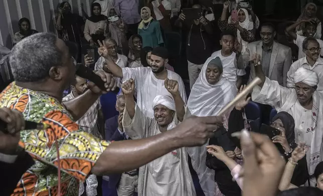 Sudanese Camirata troupe founder Dafallah el-Hag performs as Sudanese and foreign audience react during a show at the Russian culture center in Cairo, Egypt, Sunday, Sept. 15, 2024. (AP Photo/Amr Nabil)