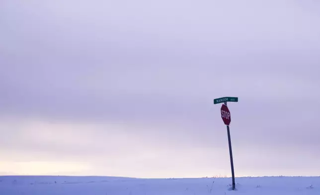 A stop sign is seen on Nanook Avenue, a word taken from the Inupiaq word for polar bear, in an undeveloped area at the edge of the village in Kaktovik, Alaska, Monday, Oct. 14, 2024. (AP Photo/Lindsey Wasson)