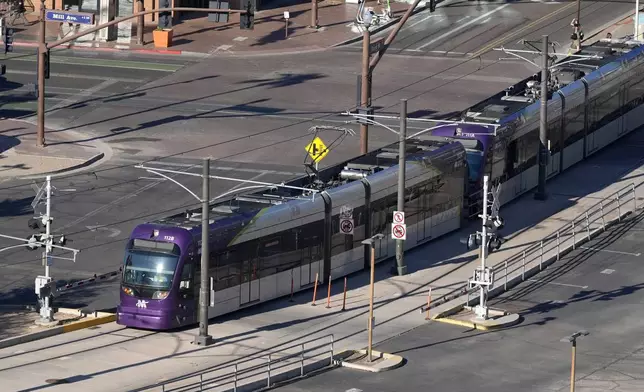 A Valley Metro Rail train moves pat Mill Ave. Tuesday, Sept. 24, 2024, in Tempe, Ariz. (AP Photo/Ross D. Franklin)