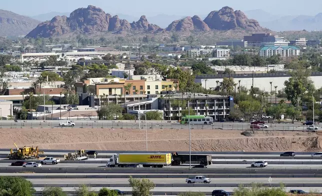 Interstate 10 slices through an area of mixed use businesses and hotels Tuesday, Sept. 24, 2024, in Tempe, Ariz. (AP Photo/Ross D. Franklin)