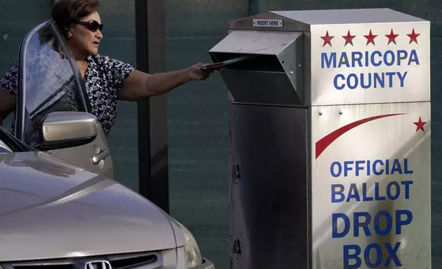 FILE - A voter casts their ballot at a secure ballot drop box at the Maricopa County Tabulation and Election Center in Phoenix, Nov. 1, 2022. (AP Photo/Matt York, File)