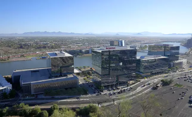 Business offices occupy the south side of Tempe Town Lake, Tuesday, Sept. 24, 2024, in Tempe, Ariz. (AP Photo/Ross D. Franklin)