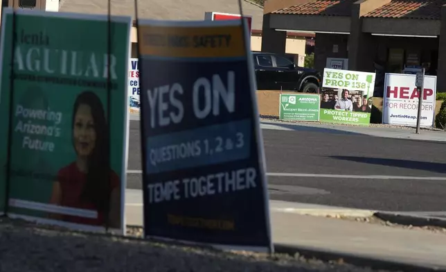 Some of the many political signs on display for the upcoming general election Thursday, Sept. 26, 2024, in Tempe, Ariz. (AP Photo/Ross D. Franklin)