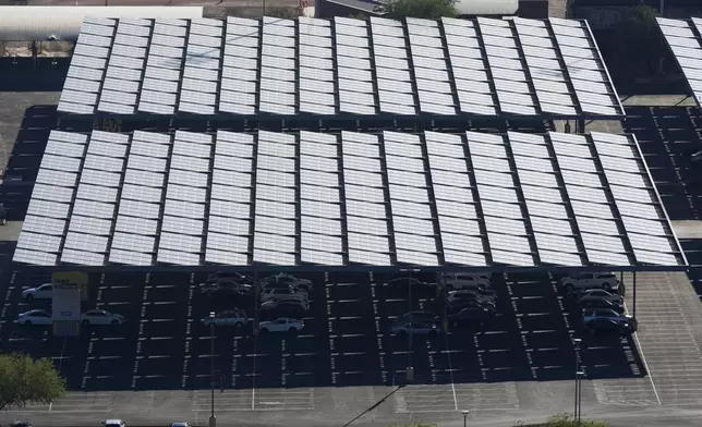 A surface parking lot is covered by solar panels at Arizona State University Tuesday, Sept. 24, 2024, in Tempe, Ariz. (AP Photo/Ross D. Franklin)