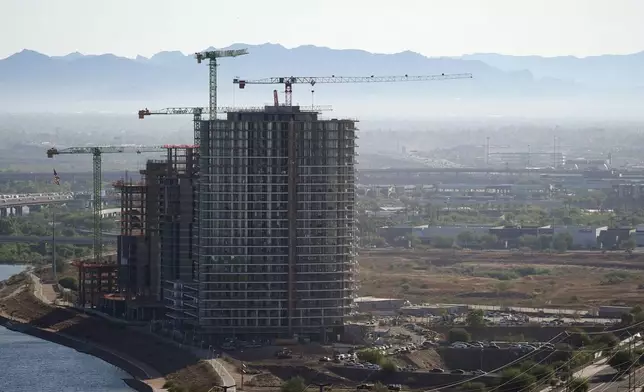 A large building is shown under construction near Tempe Town Lake Tuesday, Sept. 24, 2024, in Tempe, Ariz. (AP Photo/Ross D. Franklin)