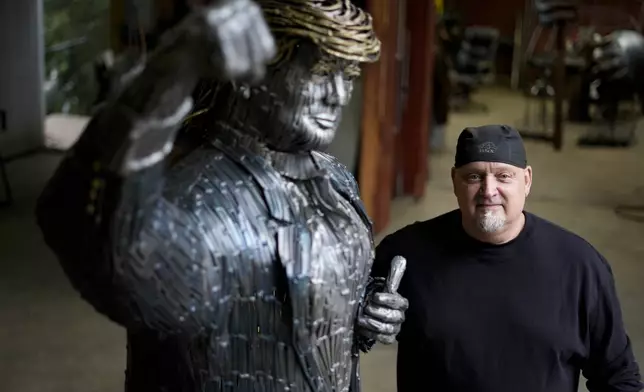 Artist Bill Secunda posses for a photograph with his sculpture of Republican presidential nominee former President Donald Trump, in Butler, Thursday, Sept. 26, 2024. (AP Photo/Matt Rourke)