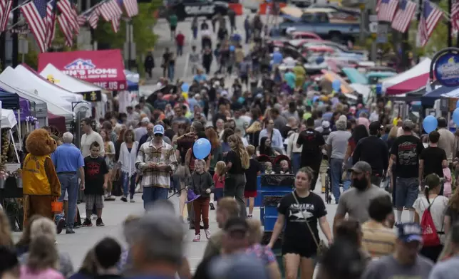 People attend the Butler Fall Festival in Butler, Saturday, Sept. 28, 2024. (AP Photo/Matt Rourke)