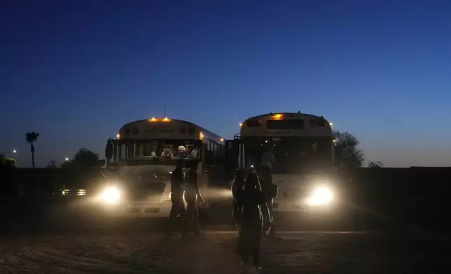 Buses get ready to depart with summer camp attendees at Valley Baptist Church, Tuesday, June 18, 2024, in Mesa, Ariz. (AP Photo/Ross D. Franklin)