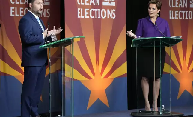 U.S. Senate candidates Rep. Ruben Gallego, D-Ariz., left, and Republican challenger Kari Lake participate in their debate, Wednesday, Oct. 9, 2024, in Phoenix. (Cheryl Evans/Arizona Republic via AP)