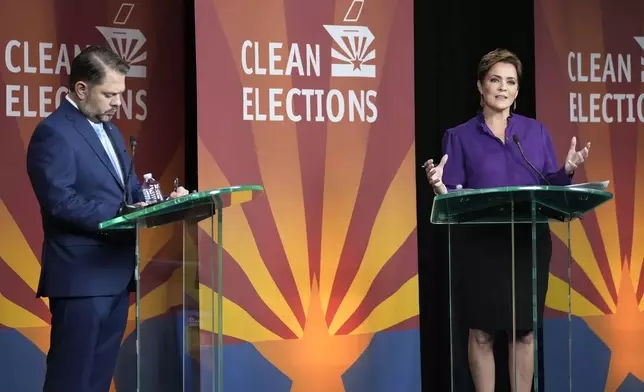 U.S. Senate candidates Rep. Ruben Gallego, D-Ariz., left, and Republican challenger Kari Lake participate in their debate, Wednesday, Oct. 9, 2024, in Phoenix. (Cheryl Evans/Arizona Republic via AP)