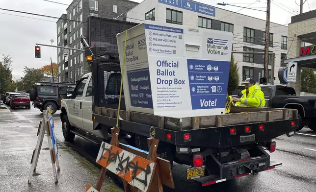 A replacement ballot drop box is unloaded on Monday, Oct. 28, 2024, in Portland, Ore. (AP Photo/Claire Rush)