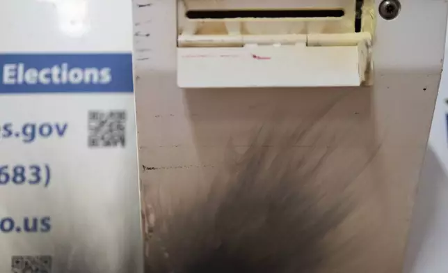 A damaged ballot drop box is displayed during a news conference at the Multnomah County Elections Division office on Monday, Oct. 28, 2024, in Portland, Ore. (AP Photo/Jenny Kane)