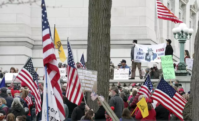 FILE - Protesters gather for a rally against Gov. Tony Evers' extended stay-at-home order due to COVID-19, at the Wisconsin State Capitol in Madison, Wis., April 24, 2020. (Amber Arnold/Wisconsin State Journal via AP, File)