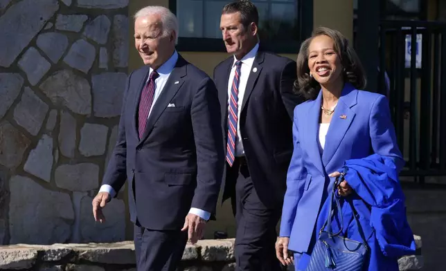 President Joe Biden, left, walks with Rep. Lisa Blunt Rochester, D-Del., after having breakfast at The Legend Restaurant &amp; Bakery, Monday, Oct. 28, 2024, in New Castle, Del. (AP Photo/Manuel Balce Ceneta)