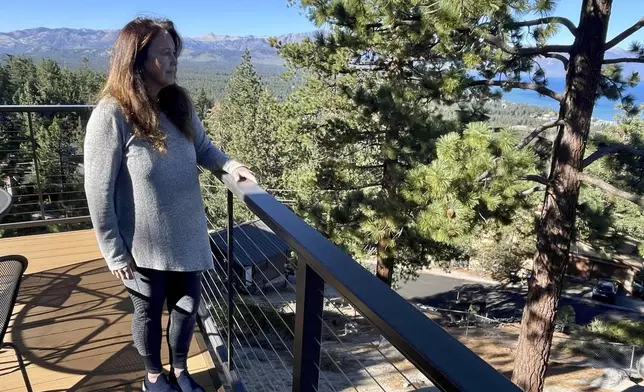 Homeowner Kelly O'Hare stands on her balcony overlooking South Lake Tahoe, Calif. on Friday, Oct. 18, 2024, where voters will decide whether to approve Measure N, which will mandate a tax to homeowners who leave their homes vacant for more than half the year. (AP Photo/Haven Daley)