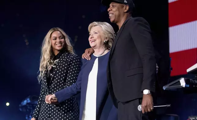 FILE - Democratic presidential candidate Hillary Clinton, center, appears on stage with artists Jay Z, right, and Beyonce during a free concert at the Wolstein Center in Cleveland, Nov. 4, 2016. (AP Photo/Andrew Harnik, File)