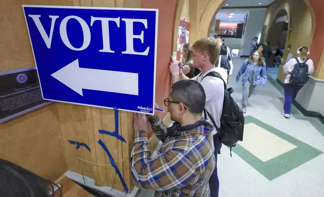 FILE - Students at The University of Wisconsin-Madison fill out ballots during the first day of Wisconsin's in-person absentee voting on the campus in Madison, Wisc., Tuesday, Oct. 22, 2024. (AP Photo/John Hart, Wisconsin State Journal, File)