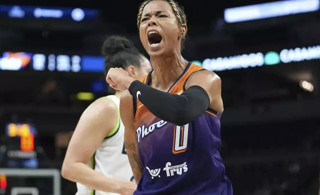 FILE - Phoenix Mercury guard Natasha Cloud (0) celebrates after making a shot while fouled during the first half of a WNBA basketball game against the Minnesota Lynx, Friday, May 31, 2024, in Minneapolis. (AP Photo/Abbie Parr, File)