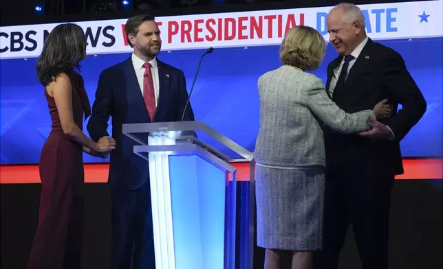 Republican vice presidential nominee Sen. JD Vance, R-Ohio, and his wife Usha Vance and and Democratic vice presidential candidate Minnesota Gov. Tim Walz and his wife Gwen Walz stand on stage after the vice presidential debate hosted by CBS News, Tuesday, Oct. 1, 2024, in New York. (AP Photo/Matt Rourke)