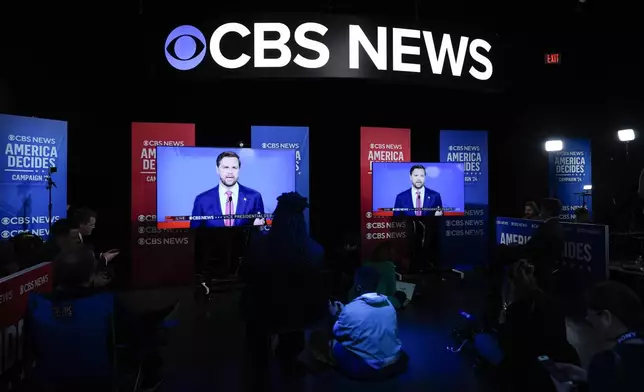 Viewers in the spin room watch the CBS News vice presidential debate, Tuesday, Oct. 1, 2024, in New York. (AP Photo/Julia Demaree Nikhinson)