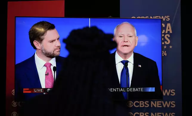 Viewers in the spin room watch the CBS News vice presidential debate, Tuesday, Oct. 1, 2024, in New York. (AP Photo/Julia Demaree Nikhinson)