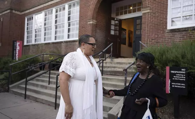 Leslie M. Scott-Jones, left, curator of learning and engagement at the Jefferson School African American Heritage Center, chats with Mattie Louis Spriggs, a close friend, Oct. 10, 2024, in Charlottesville, Va. (AP Photo/Serkan Gurbuz)