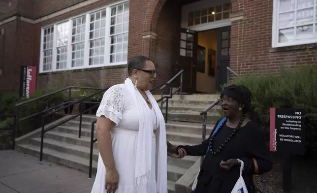 Leslie M. Scott-Jones, left, curator of learning and engagement at the Jefferson School African American Heritage Center, chats with Mattie Louis Spriggs, a close friend, Oct. 10, 2024, in Charlottesville, Va. (AP Photo/Serkan Gurbuz)