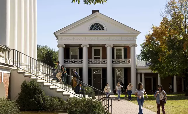 People climb steps to the Rotunda at the University of Virginia in Charlottesville, Va., Friday, Oct. 11, 2024. (AP Photo/Ryan M. Kelly)