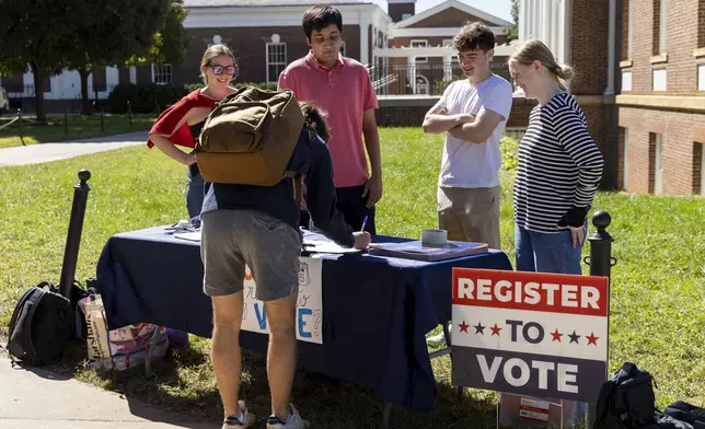 Eleanor Clemons, Kushaan Soodan, James Galvin and Cate Love register students to vote at the University of Virginia in Charlottesville, Va., Friday, Oct. 11, 2024. (AP Photo/Ryan M. Kelly)